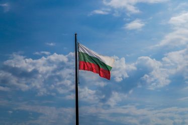 Bulgarian flag waving against a clear blue sky