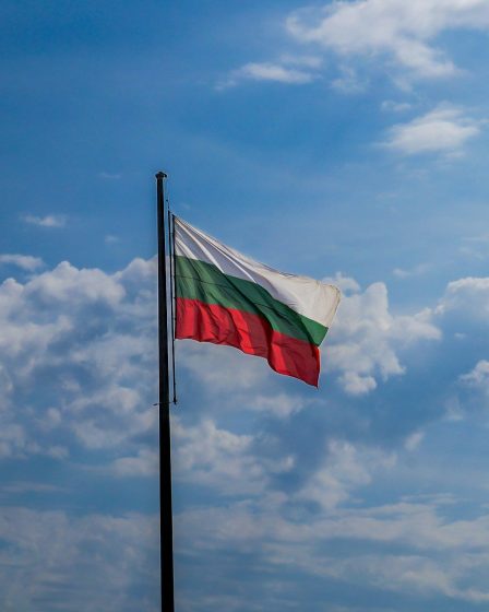 Bulgarian flag waving against a clear blue sky