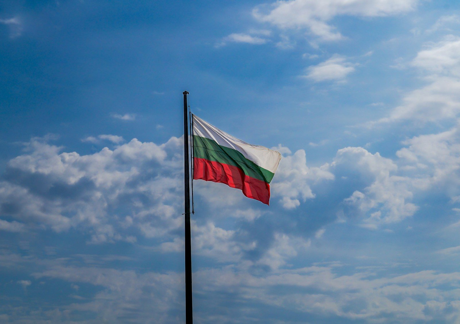 Bulgarian flag waving against a clear blue sky