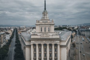 The National Assembly building in Sofia beneath a cloudy sky