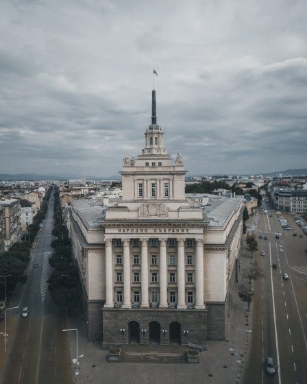 The National Assembly building in Sofia beneath a cloudy sky