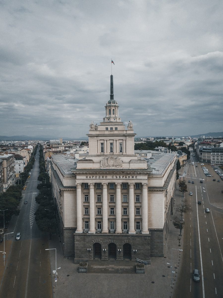The National Assembly building in Sofia beneath a cloudy sky