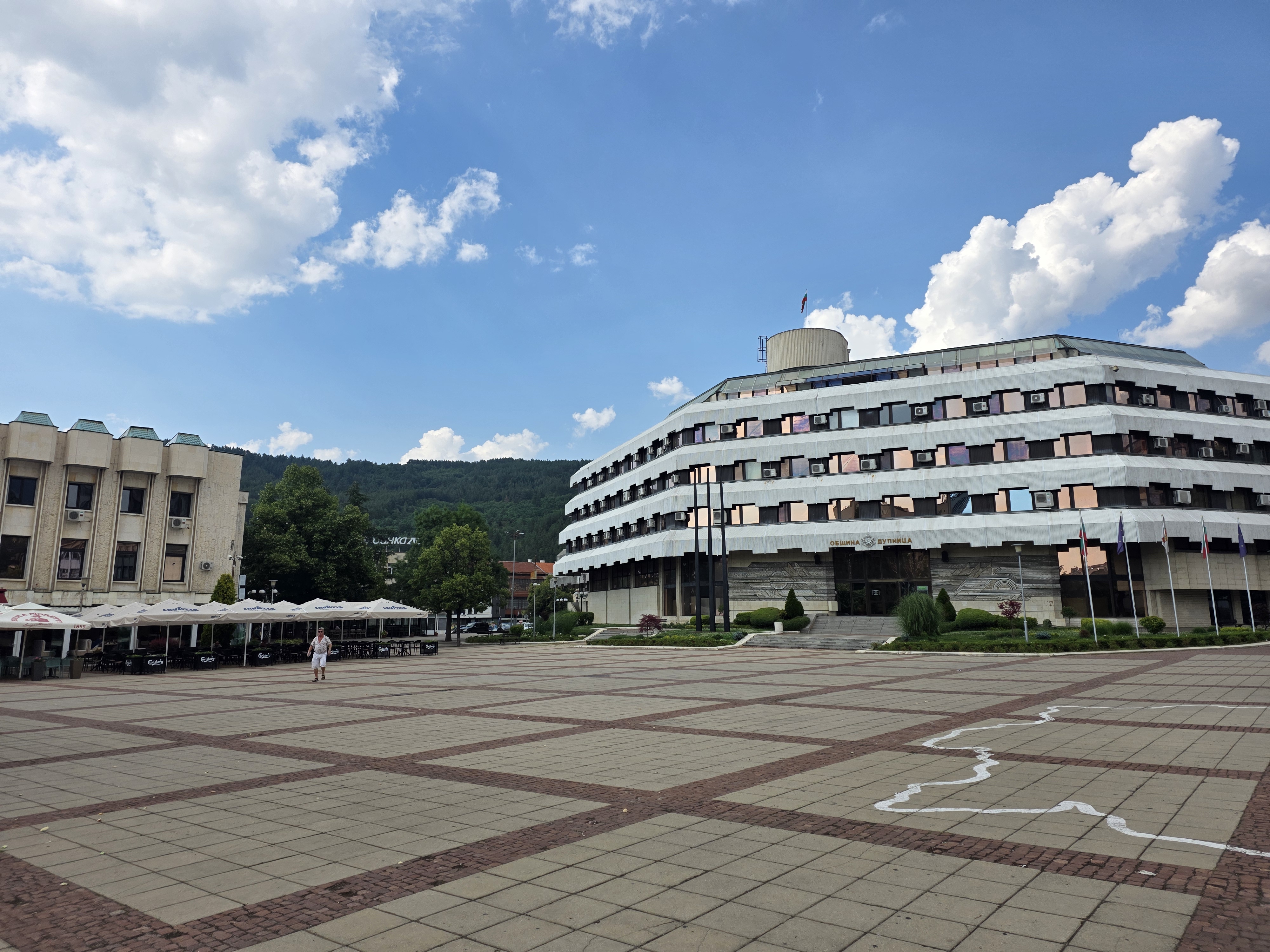 The main square in Dupnitsa with the municipality building and the mountains on the horizon