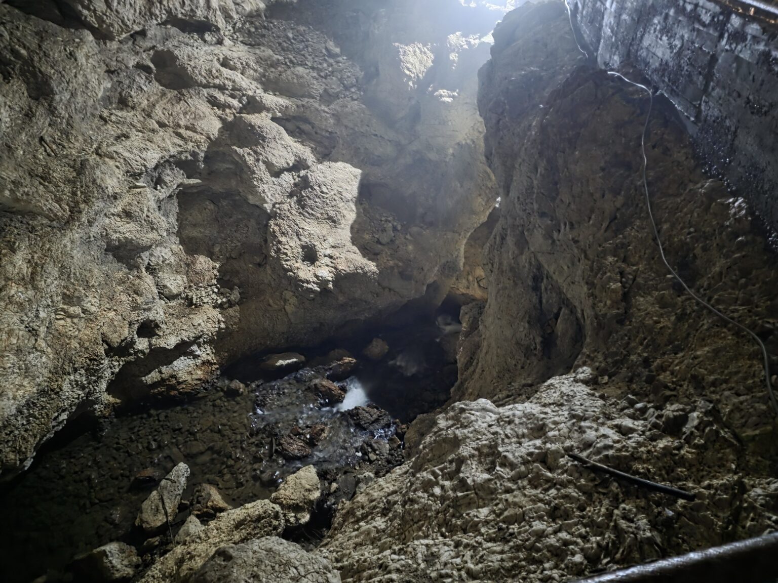 Rock walls and running water inside dyavolskoto garlo cave hall