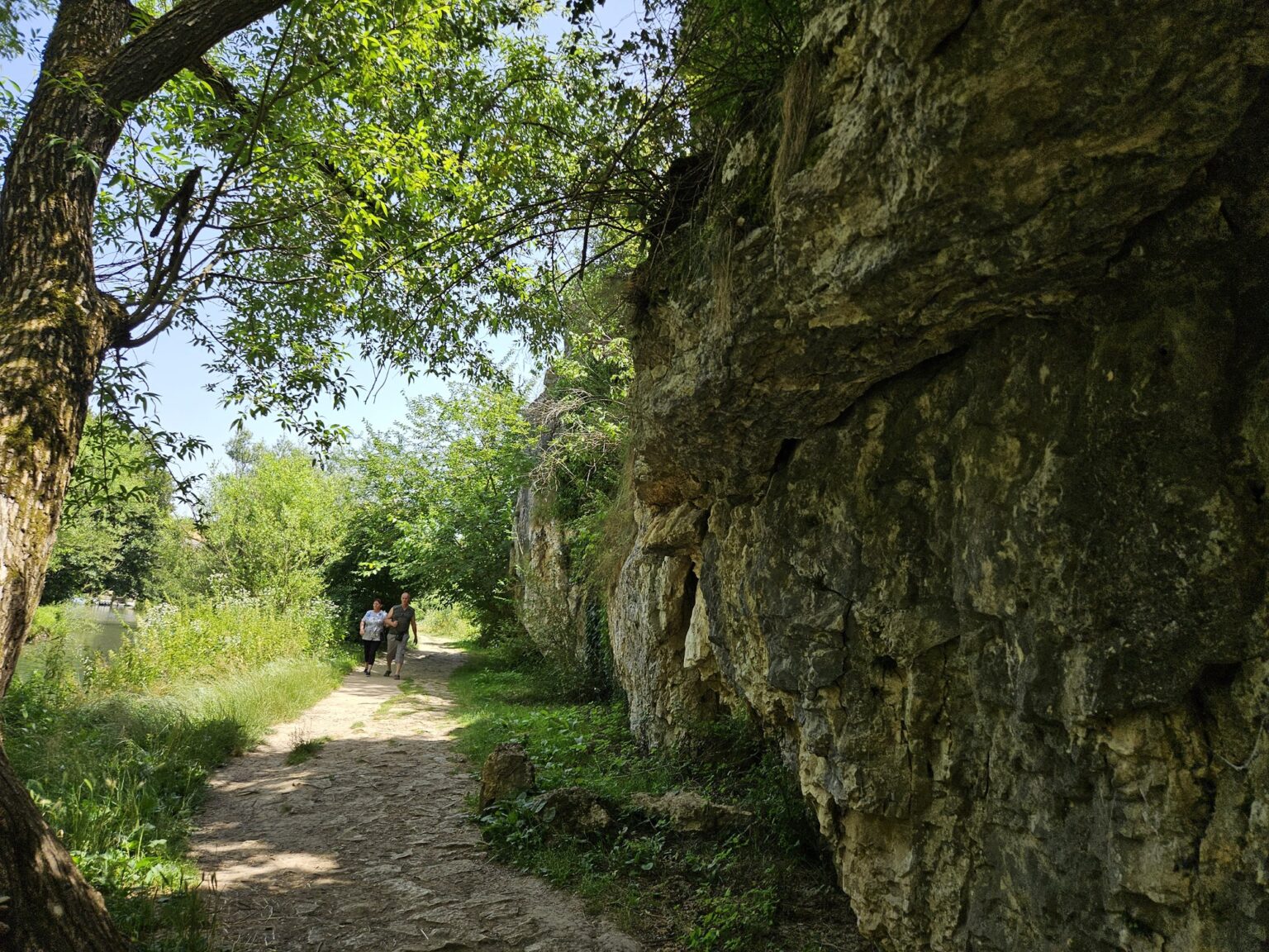 Sunny forest path along a rocky slope in Iskar-Panega eco-trail