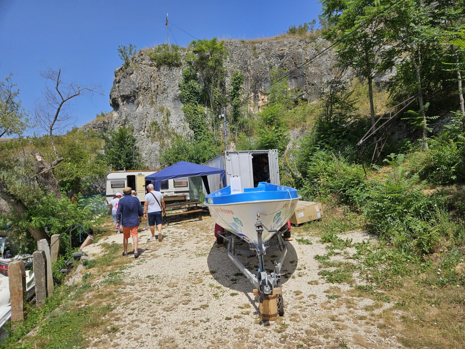 Boat and caravan near a rock formation