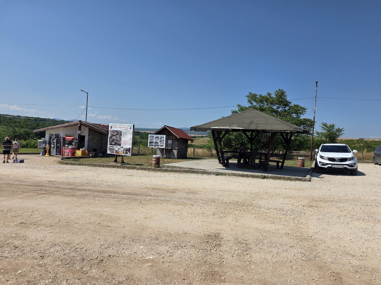 Gazebo and small buildings near an open parking lot