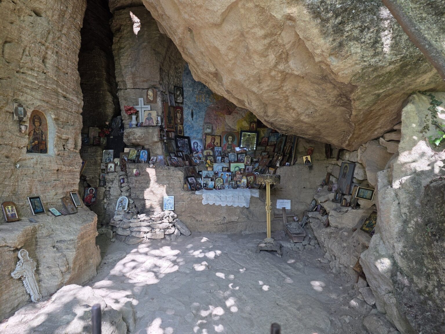 Rock chapel with icons and offerings in Madara Rider