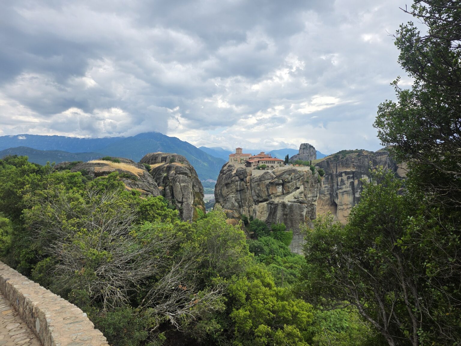 Rock massifs with a monastery through tree branches