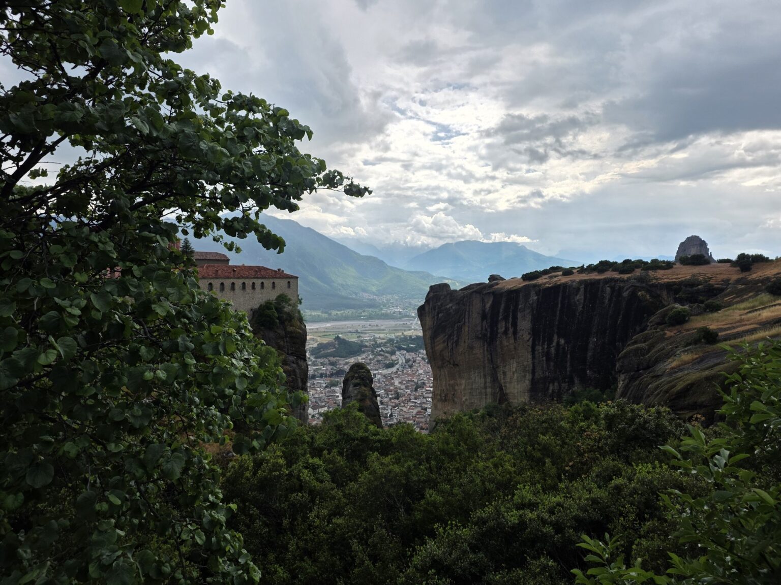 View of rocks and a valley through tree branches