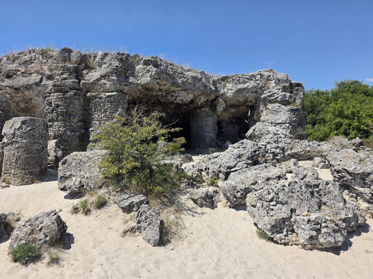 Massive rock formations amidst the sand at pobiti kamani