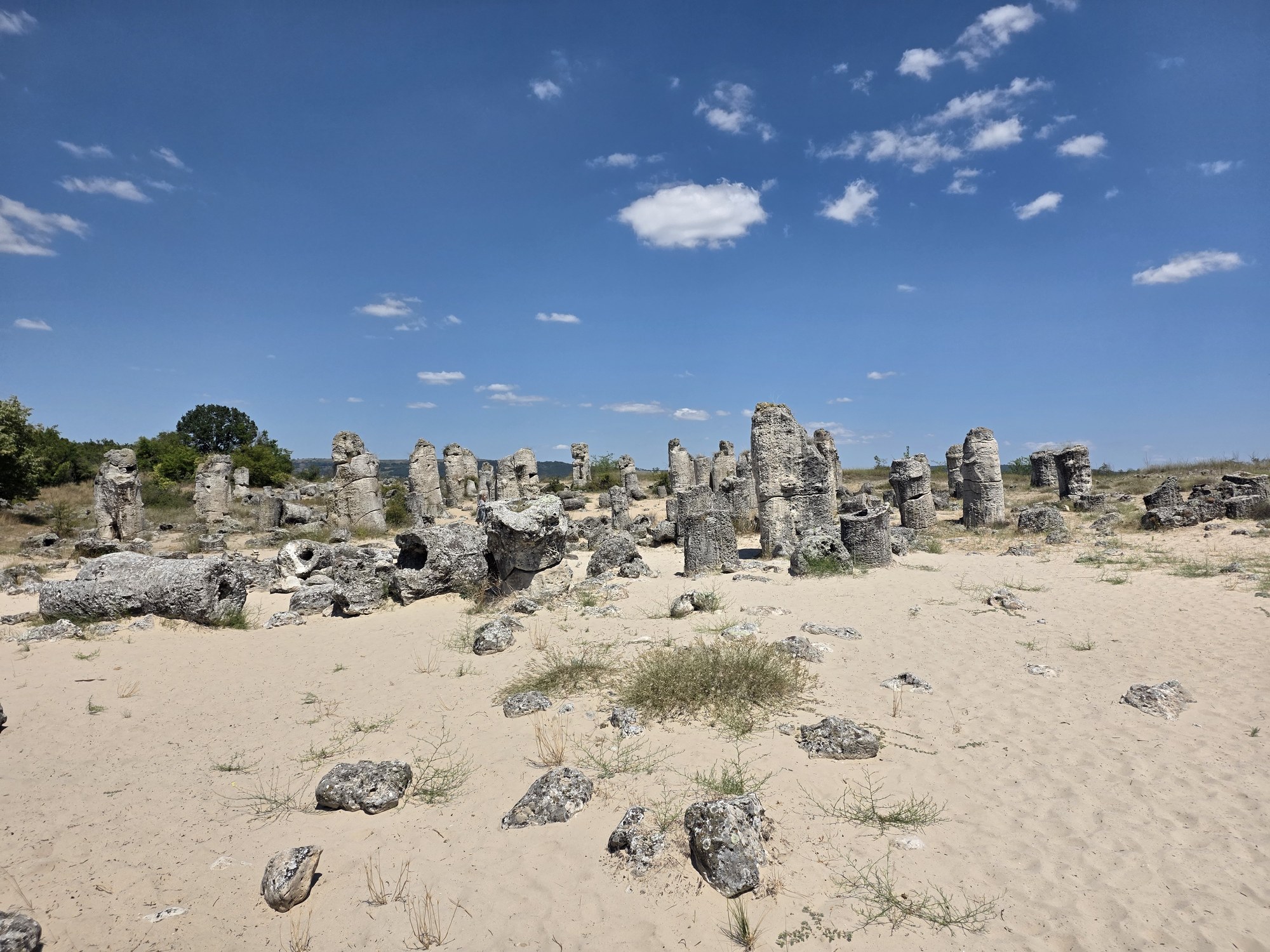 Tall stone columns under an open blue sky
